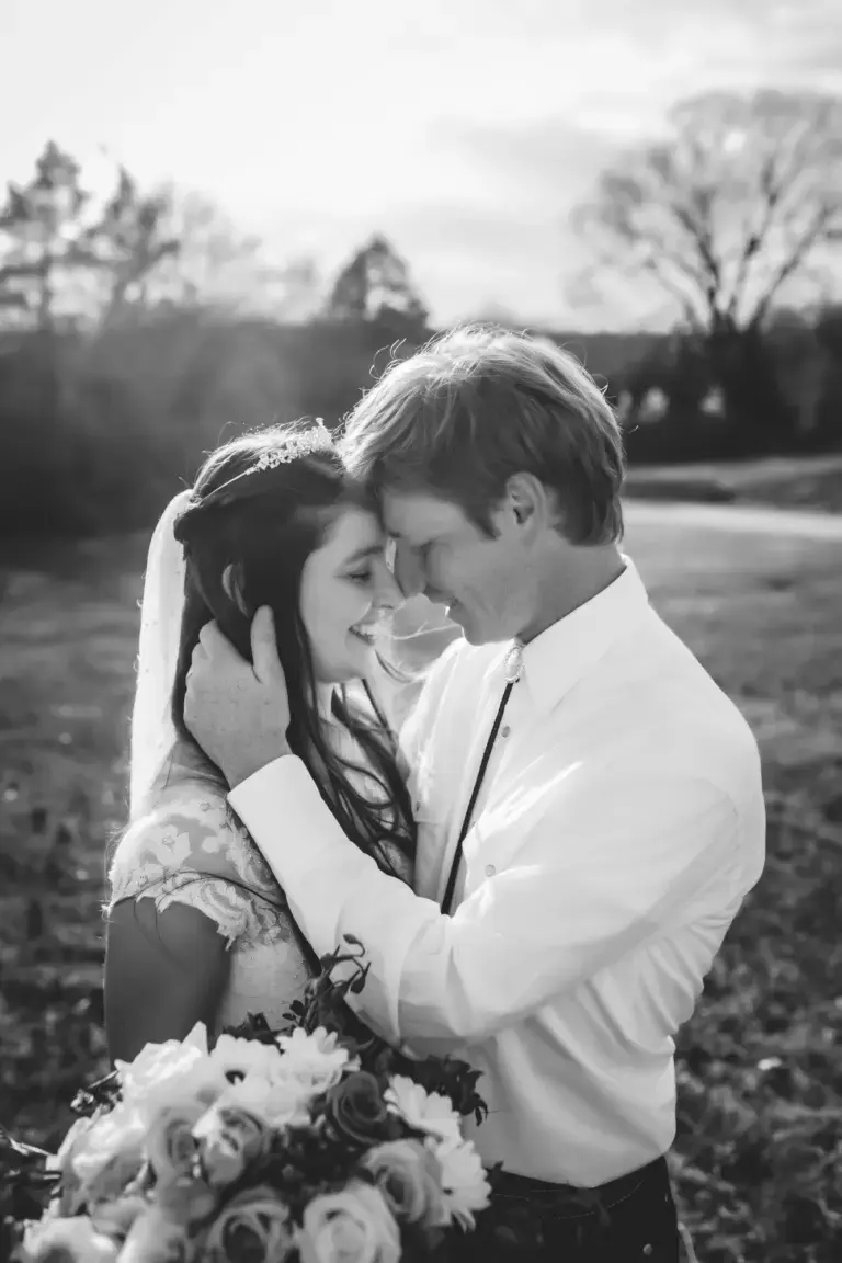 Black and white wedding photo of Brittney and her husband with foreheads touching, after waiting on God for a husband she got the fairytale ending she craved.
