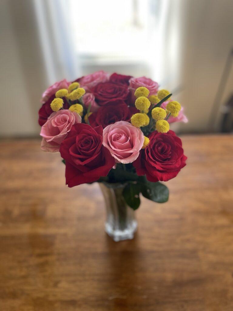 A bouquet of pink and red roses on a table, for a study on what the Bible says about miscarriage.