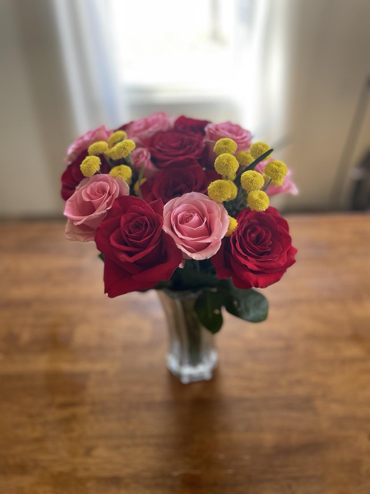 A bouquet of pink and red roses on a table, for a study on what the Bible says about miscarriage.