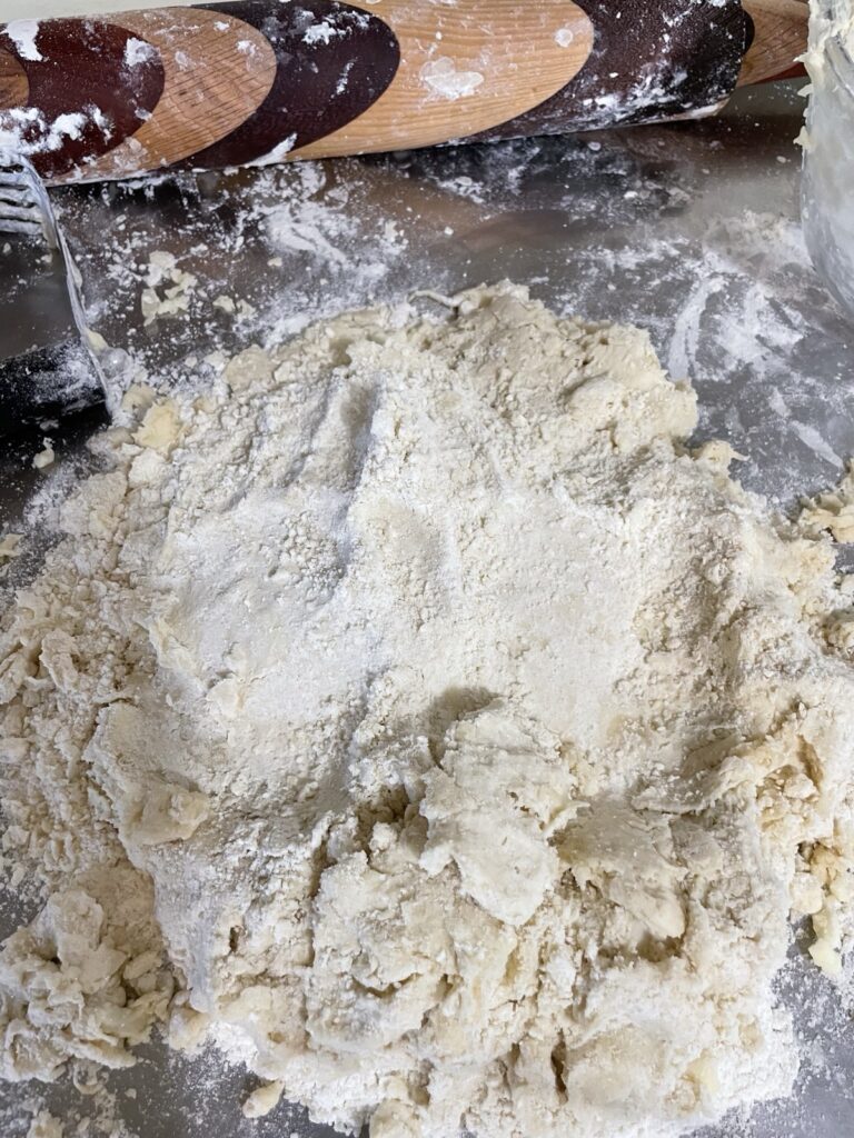 Extra dry bits of flour are pressed into the top of the dough before the first folds in the simple lamination process.