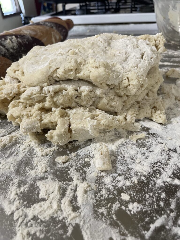 Biscuit dough folded in half twice to make flakey layers with a simple lamination process.
