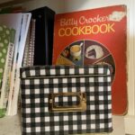 Recipe box with cookbooks behind it representing how the simple stress-free sourdough seminar teaches the ratio to convert recipes to sourdough.